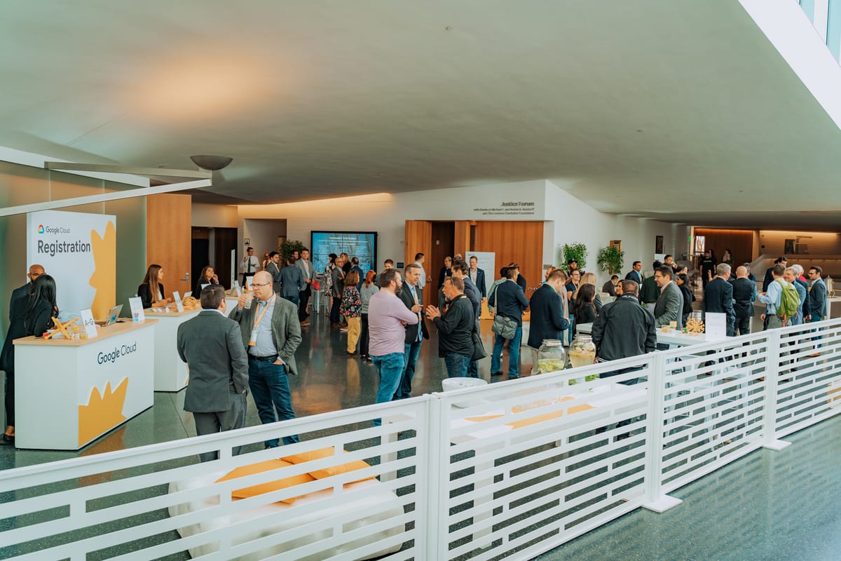 Google Cloud registration area with attendees gathering across a bright conference lobby