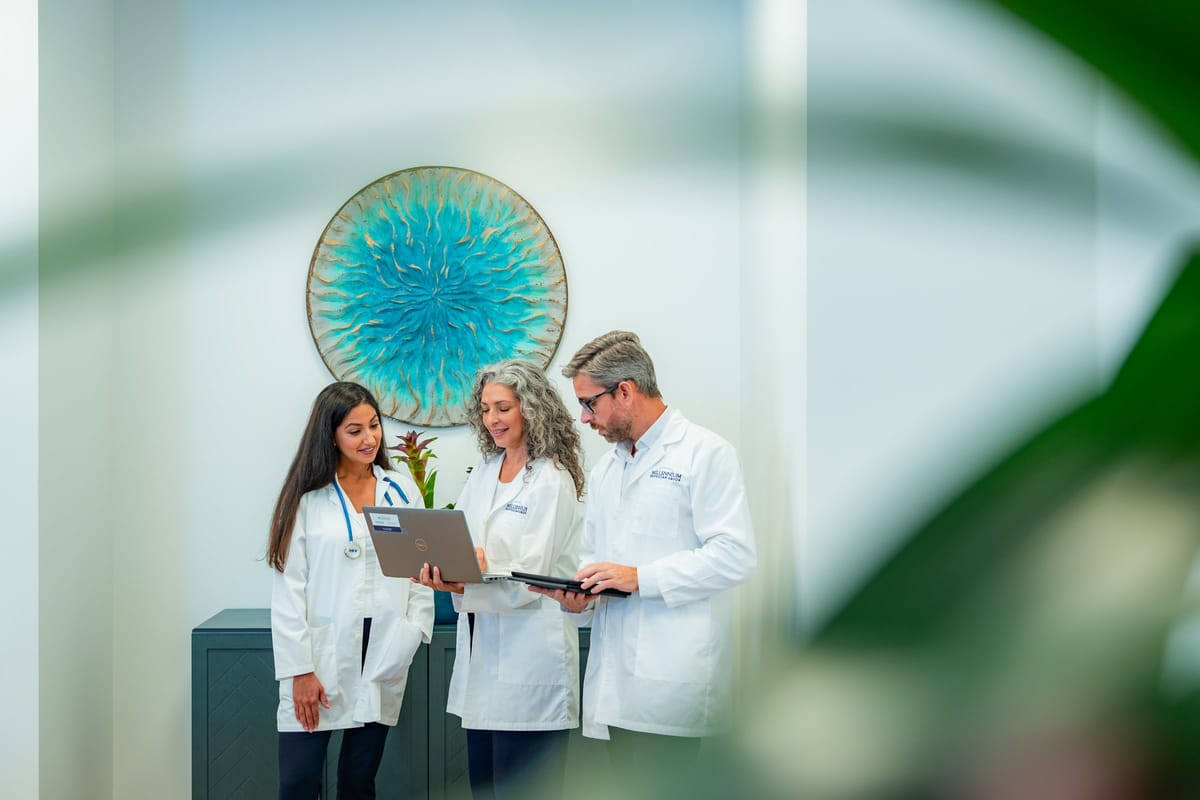 Millennium Physician Group staff collaborating at the clinic front desk