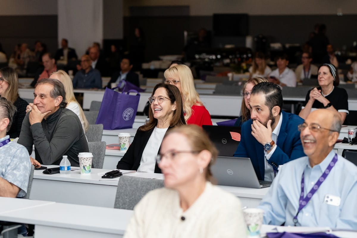 Medical professionals listening during a cardiovascular summit presentation