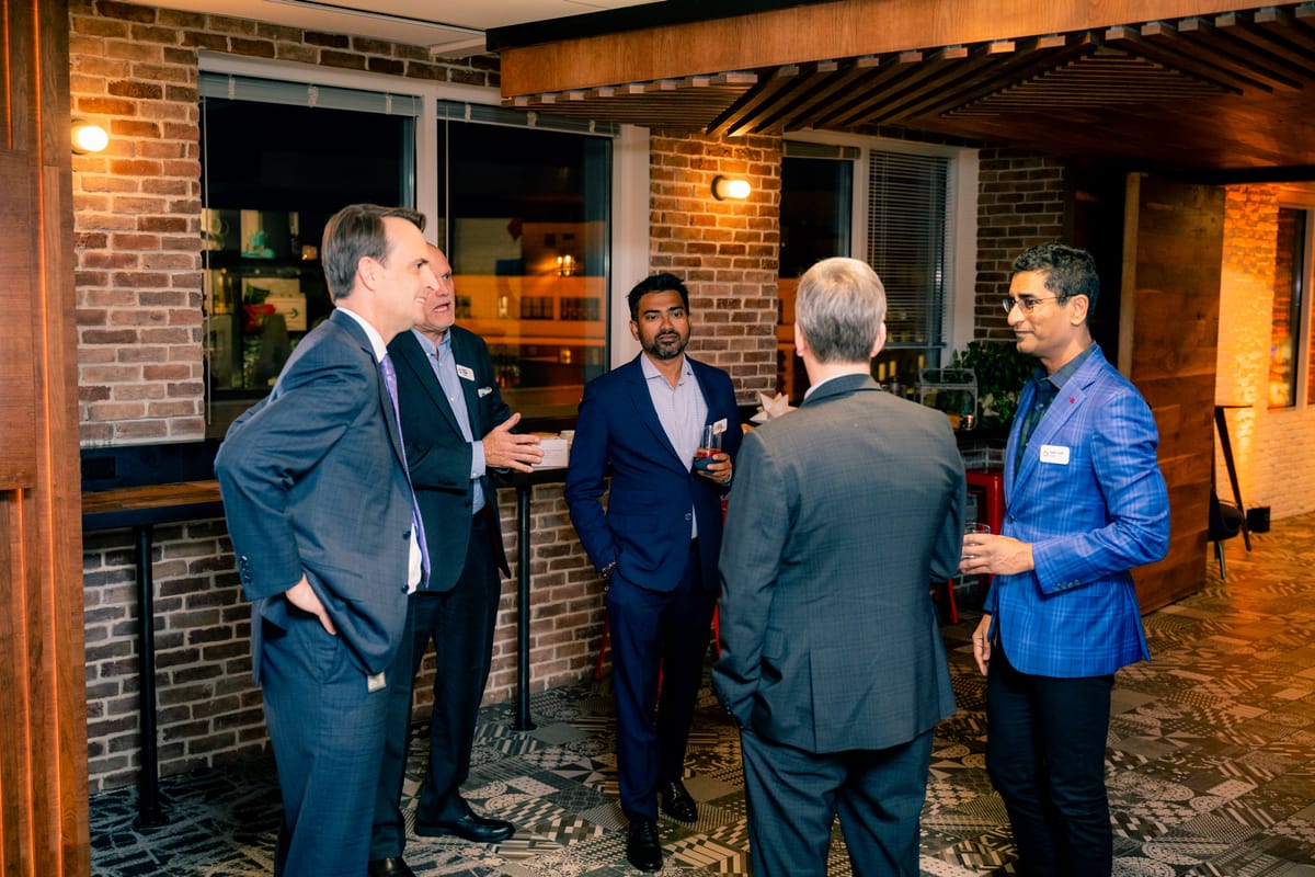 Executives in conversation during an evening corporate gathering in Washington DC
