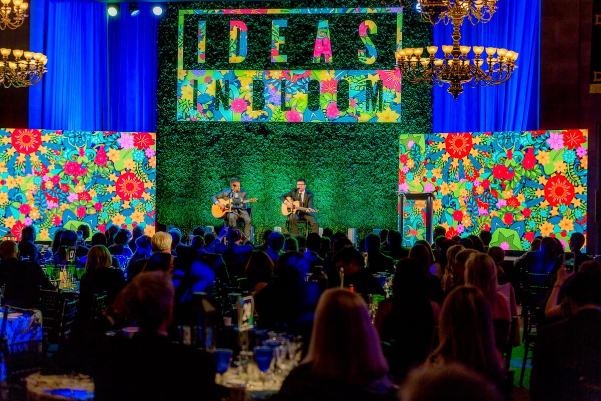 U.S. Chamber of Commerce IP Champions stage with live musicians, vivid floral graphics, and a seated audience