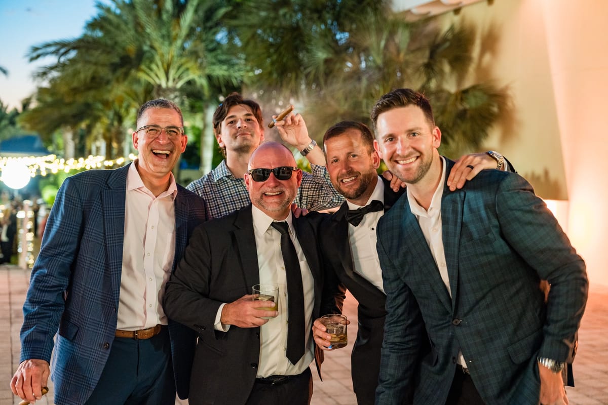Four TAG Advisors guests laughing together during the evening celebration