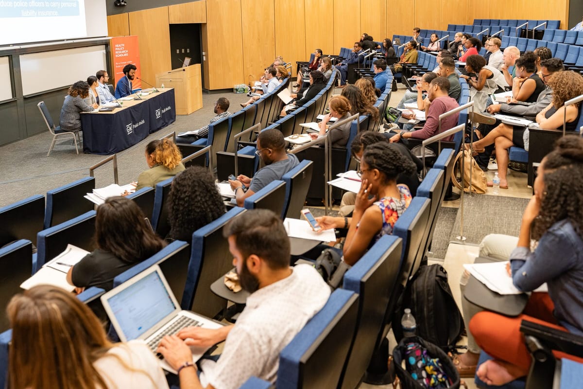 Scholars in a lecture hall during a Health Policy Research Scholars session