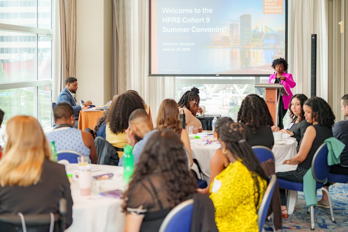 Speaker at a podium welcoming scholars to the HPRS Cohort 9 Summer Convening in Baltimore, June 2026