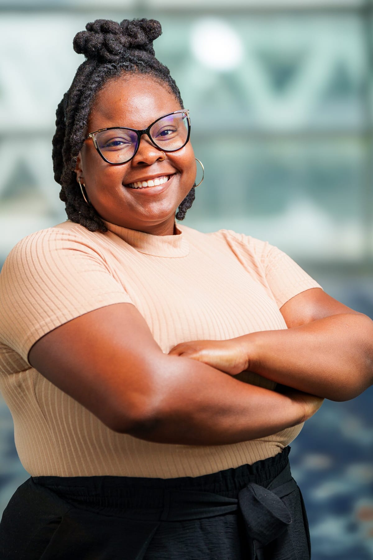 Scholar headshot, arms crossed, matching the set's consistent look